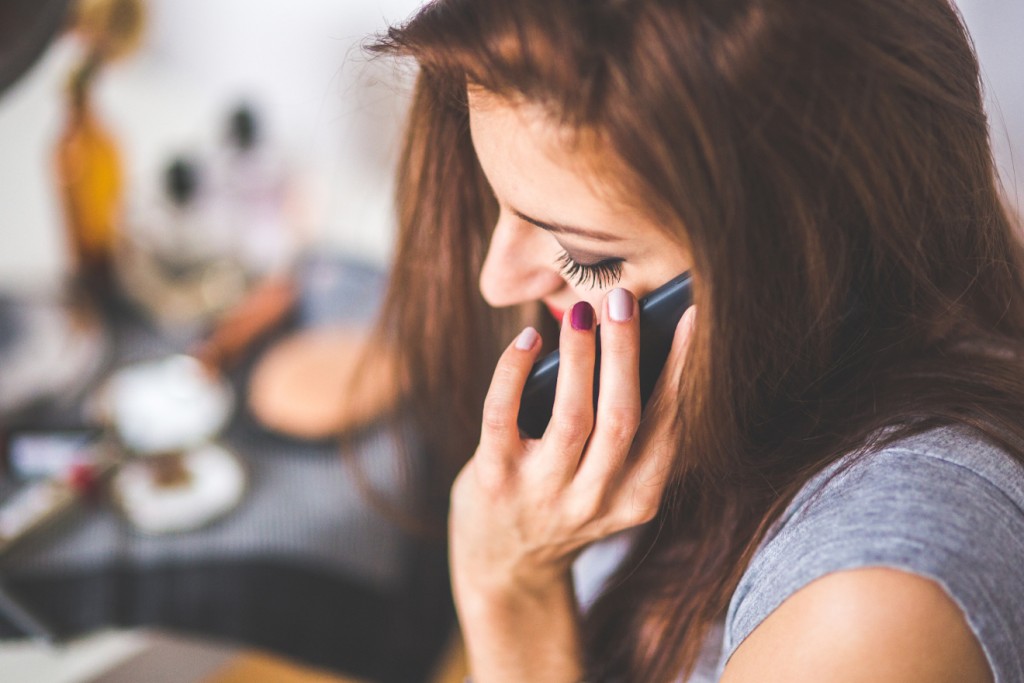 kaboompics.com_Closeup-portrait-of-young-lady-talking-on-mobile-phone